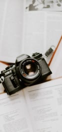 black nikon dslr camera on white printer paper