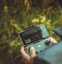 person holding black and gray digital camera