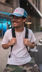 man in white crew neck t-shirt wearing blue cap and black sunglasses