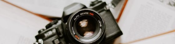 black nikon dslr camera on white printer paper
