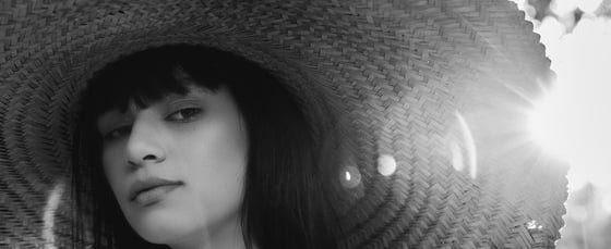 woman in white crew neck shirt wearing brown sun hat