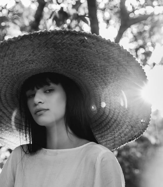 woman in white crew neck shirt wearing brown sun hat