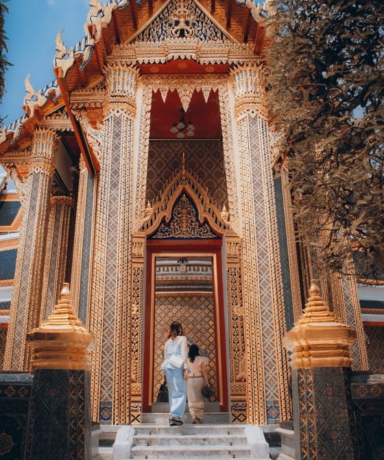 man and woman standing in front of brown concrete building during daytime