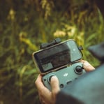 person holding black and gray digital camera