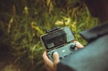 person holding black and gray digital camera