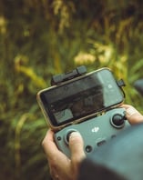 person holding black and gray digital camera