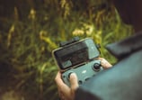 person holding black and gray digital camera
