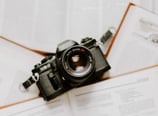black nikon dslr camera on white printer paper