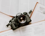 black nikon dslr camera on white printer paper