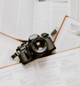 black nikon dslr camera on white printer paper