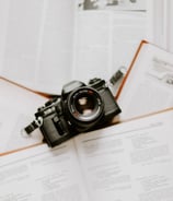 black nikon dslr camera on white printer paper