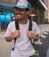 man in white crew neck t-shirt wearing blue cap and black sunglasses