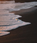 ocean waves crashing on shore during daytime