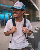 man in white crew neck t-shirt wearing blue cap and black sunglasses