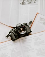 black nikon dslr camera on white printer paper