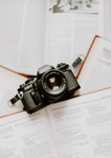 black nikon dslr camera on white printer paper