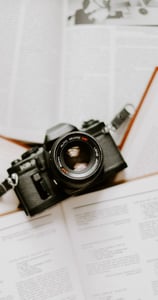 black nikon dslr camera on white printer paper