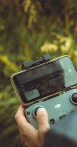 person holding black and gray digital camera
