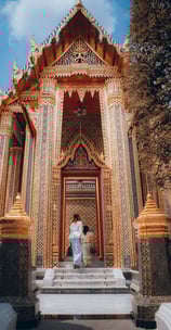 man and woman standing in front of brown concrete building during daytime