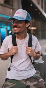 man in white crew neck t-shirt wearing blue cap and black sunglasses