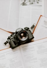 black nikon dslr camera on white printer paper