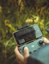 person holding black and gray digital camera