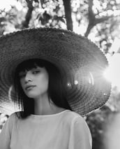 woman in white crew neck shirt wearing brown sun hat
