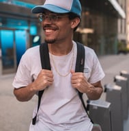 man in white crew neck t-shirt wearing blue cap and black sunglasses