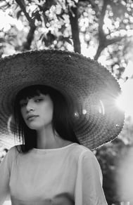 woman in white crew neck shirt wearing brown sun hat