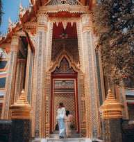 man and woman standing in front of brown concrete building during daytime