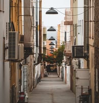 empty hallway between concrete buildings during daytime