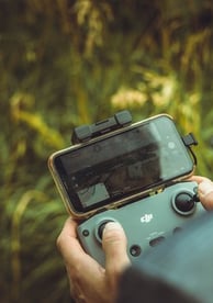 person holding black and gray digital camera