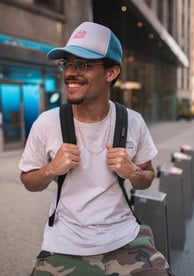 man in white crew neck t-shirt wearing blue cap and black sunglasses