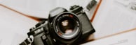 black nikon dslr camera on white printer paper