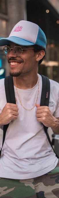 man in white crew neck t-shirt wearing blue cap and black sunglasses