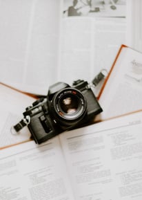 black nikon dslr camera on white printer paper