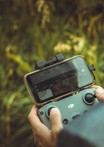 person holding black and gray digital camera