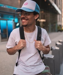 man in white crew neck t-shirt wearing blue cap and black sunglasses