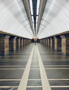 man in black jacket walking on hallway