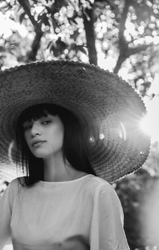 woman in white crew neck shirt wearing brown sun hat