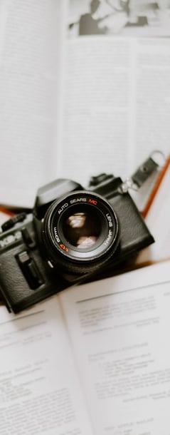 black nikon dslr camera on white printer paper