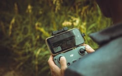 person holding black and gray digital camera