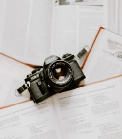black nikon dslr camera on white printer paper