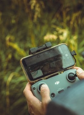 person holding black and gray digital camera
