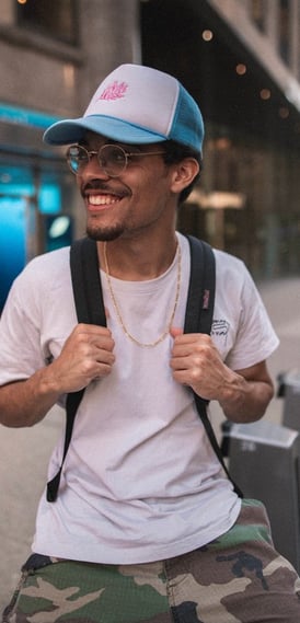man in white crew neck t-shirt wearing blue cap and black sunglasses