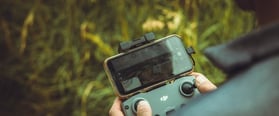 person holding black and gray digital camera