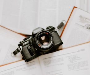 black nikon dslr camera on white printer paper