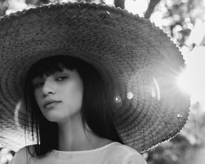 woman in white crew neck shirt wearing brown sun hat