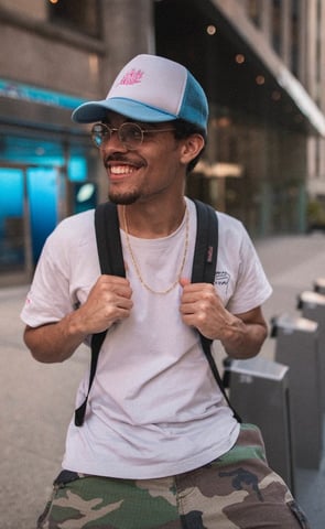 man in white crew neck t-shirt wearing blue cap and black sunglasses