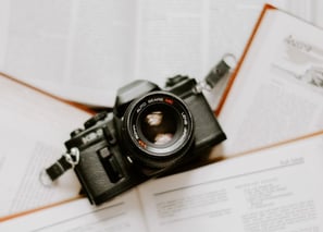 black nikon dslr camera on white printer paper